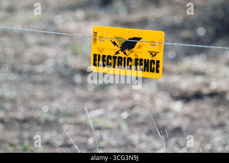Electric fence sign on rural property, livestock fencing and grazing, shock hazard Stock Photo
