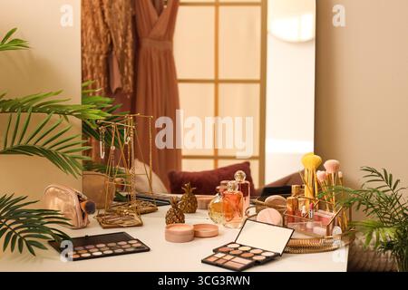 Makeup products on table in dressing room Stock Photo
