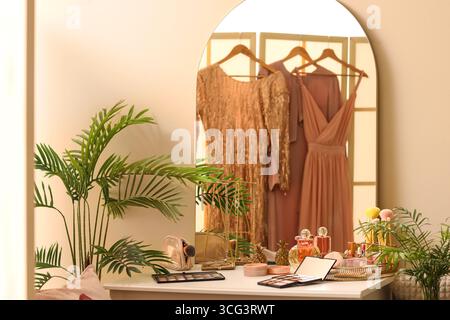 Makeup products on table in dressing room Stock Photo