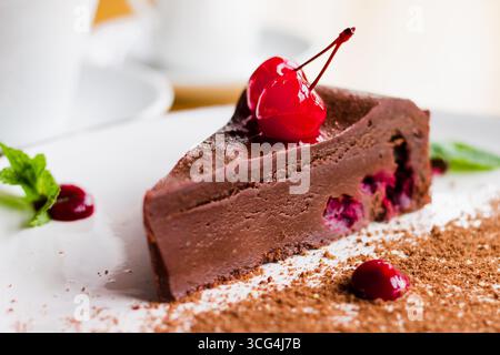 Chocolate cake cherry brownies. Sweet ?hocolate dessert with ?herry. A slice of cake in a cafe on the plate. Homemade sweets recipes Stock Photo