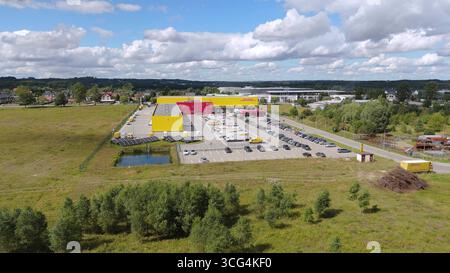 Aerial high angle view of a modern DHL logistics hub and distribution warehouse with solar panels, representing sustainable supply chain, global trade Stock Photo