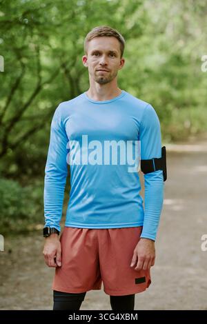 Portrait of Young Adult Caucasian Man Standing Outdoors during Morning Workout Stock Photo