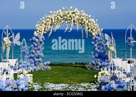 outdoor wedding arch and chairs against a blue ocean background Stock Photo