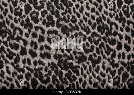 Animal-inspired leopard print pattern in grayscale tones on a soft, textured fabric. Suitable for fashion, textile design, or modern interior decor Stock Photo