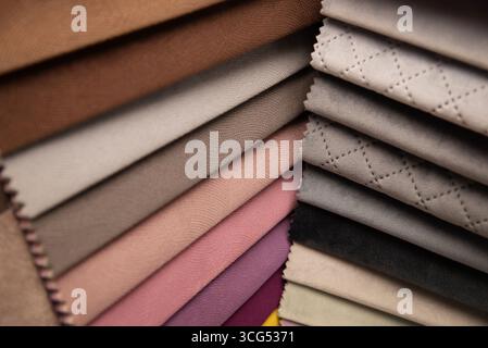 A neatly arranged stack of different textiles showcasing various colors, textures, and surface patterns, perfect for design inspiration or fabric Stock Photo