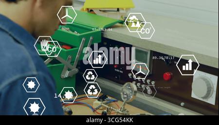 Assembling technician testing circuit board at bench, with green toolbox and AR icons, copy space Stock Photo
