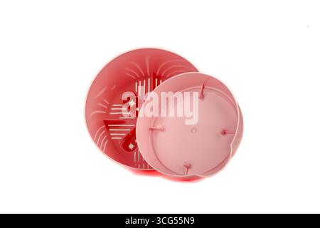 Pink plastic empty flower pot with tray on white background. Copy space. Stock Photo