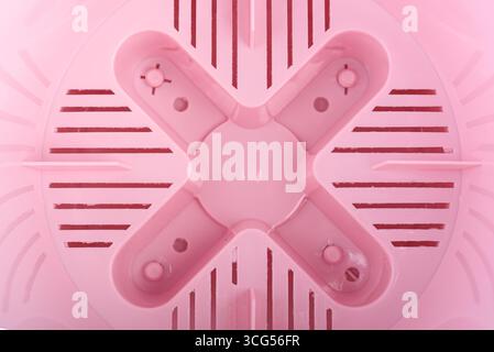 Top view of the bottom of the inside of a plastic empty flower pot. Close-up. Stock Photo