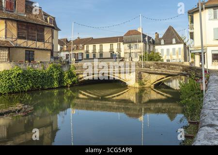 Scenic view of the old stone bridge reflecting in the calm river during a sunny morning in the charming village of salies de bearn, france Stock Photo