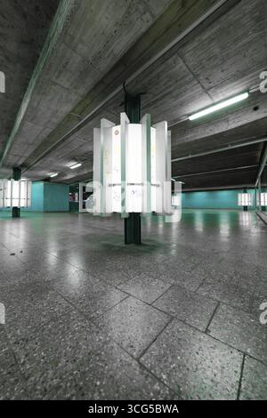 An empty, underground space with concrete walls and glowing green light creates a modern, urban atmosphere, Munich, Germany Stock Photo