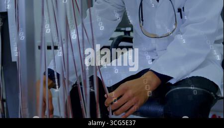 Male medical professional in white lab coat wiring colored cables in clinical lab, with stethoscope Stock Photo