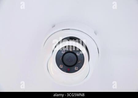 CCTV camera on the hull of an expensive motor yacht. CCTV camera white on a white body. Stock Photo