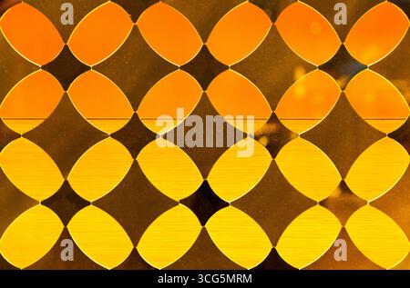 Yellow decorative translucent glass with a diamond pattern. Stock Photo