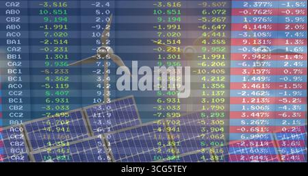 Displaying translucent data grid overlaying solar panels wind turbine in art, with EV charger icon Stock Photo