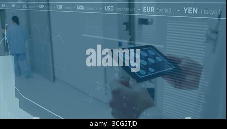Examining brain scans doctor wearing coat holding tablet in hospital with floating finance charts Stock Photo