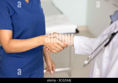 Two female doctors giving handshake close up Stock Photo