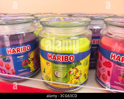Wroclaw, Poland - August 8, 2025: Brightly colored jars filled with various fruit-flavored candies sit neatly on a shelf in a vibrant store. Stock Photo