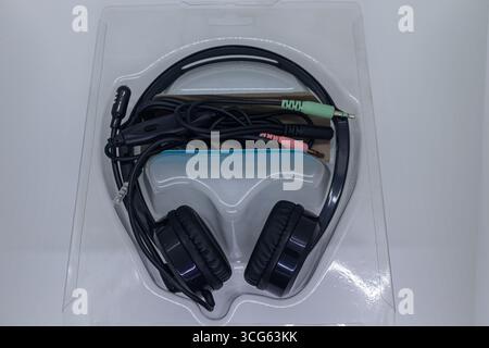 Close-up image of black wired headphones isolated on a clean white background. Perfect for showcasing audio equipment, electronics, music accessories. Stock Photo
