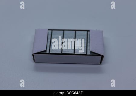 Close-up shot of a bundle of stapler pins neatly stacked together. Essential office supply item used for paper fastening, showcasing metallic texture Stock Photo