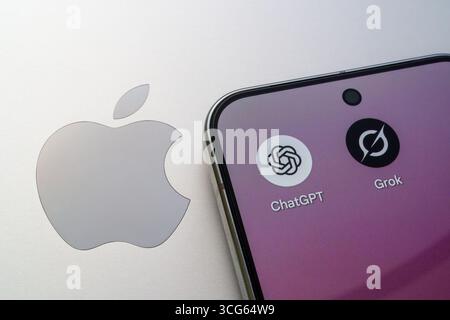 ChatGPT and Grok AI chatbot apps on smartphone screen next to Apple logo, showing tech rivalry and mobile AI. Stafford, United Kingdom, August 26, 202 Stock Photo