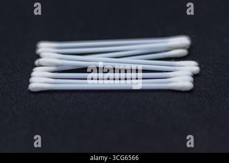 Close-up image of cotton swabs used for ear cleaning, showing soft cotton tips on plastic sticks. Hygiene and personal care concept in a clean. Stock Photo
