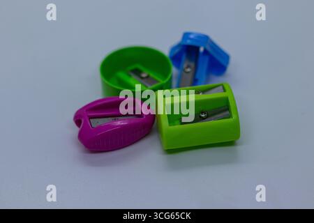 Set of colorful plastic pencil sharpeners arranged on a clean white background. Essential stationery tools for students, artists, and office use. Comp Stock Photo