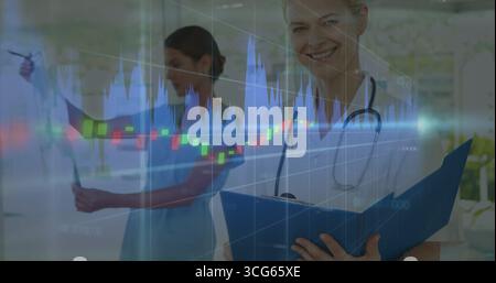 Analyzing candlestick overlay, doctor holding folder, nurse reading X-ray in corridor, copy space Stock Photo