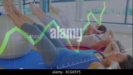 Crunching three women in sportswear lying on mats in gym, with grid overlay showing green uptrend Stock Photo