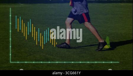 Running man wearing gray top and shorts on turf with green cone and virtual chart overlay Stock Photo