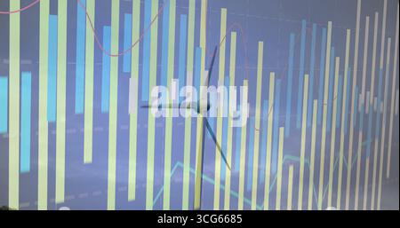 Displaying wind turbine silhouette hovering over bar charts at dashboard, with line graph overlays Stock Photo
