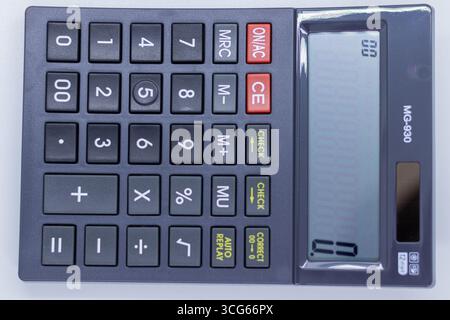 Compact calculator with a sleek gray body, ideal for office, school, and personal use. Portable and user-friendly device for quick calculations, budge Stock Photo