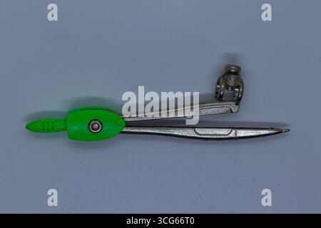 Compact pencil compass designed for drawing precise circles. Ideal for students, architects, engineers, and artists. Useful stationery tool for geomet Stock Photo