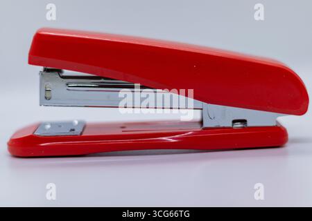 Compact stapler machine designed for desktop use, ideal for office, school, or home. Modern, portable, and efficient stationery tool for binding paper Stock Photo