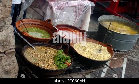 Corn kernels cooked with epazote of various flavors in clay pots. Esquites typical Mexican dish prepared with cream, cheese, chili powder and lemon Stock Photo
