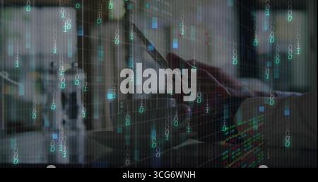 Typing focused adult man analyzing streaming code at desk workspace, with smartphone and laptop Stock Photo