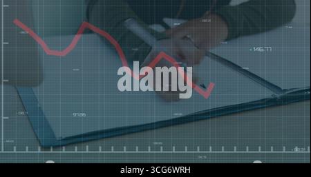 Writing analyst tracing red line graph across notebook on desk, with pen smartphone grid overlay Stock Photo
