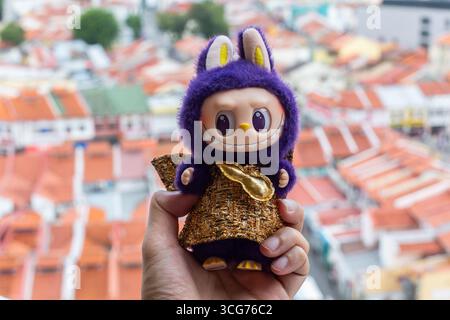 Purple colour Labubu in gold shiny dress posing on a gate grill design on street at Little India, Singapore Stock Photo - Alamy Purple colour Labubu in gold shiny dress posing on a gate grill design on street at Little India, Singapore Stock Photo - Alamy
