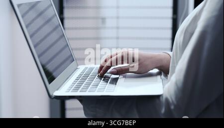 Business, hands and woman with laptop, programmer and software engineering with cyber security. Closeup, coder or person in workplace, pc or writing Stock Photo