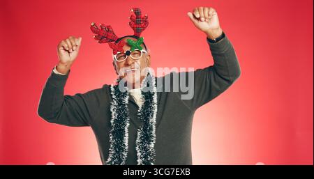 Christmas, dance and portrait of senior man in studio for holiday, vacation and festive season. Space, energy and elderly person for xmas celebration Stock Photo
