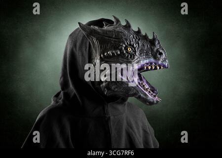 Portrait of a dragon with hooded cape over dark foggy background. Stock Photo
