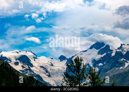 Beautiful View over the Swiss Alps with Glacier Morteratsch, Piz Bernina (4,049 m), Piz Pal³ (3,901 m), Piz Roseg (3,937 m) and Bellavista in a Sunny Stock Photo