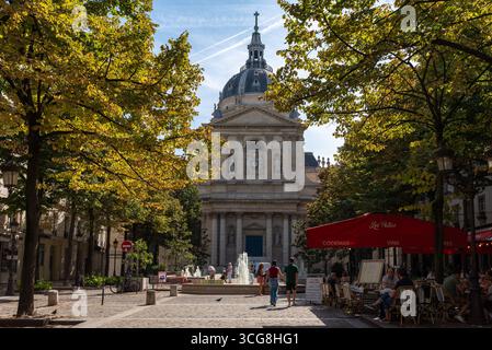 The Sorbonne Chapel on Place de la Sorbonne in the 5th arrondissement of Paris. People having a drink and enjoying the warm sunny weather Stock Photo