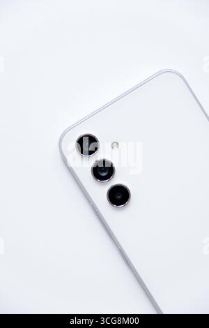 Mobile phone with triple lens camera isolated on white background Stock Photo