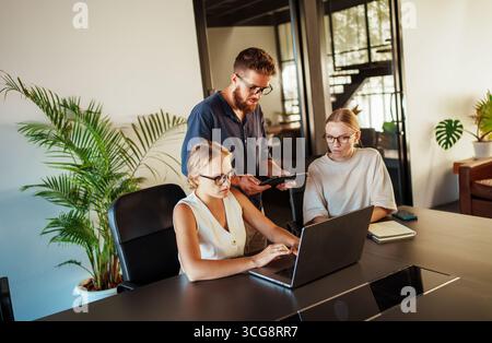 Engaging in a Collaborative Work Session within a Contemporary Modern Office Space Setting Stock Photo
