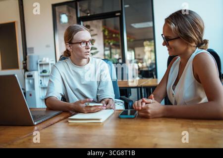 Collaborative meetings in a modern workspace are essential for team success and growth Stock Photo