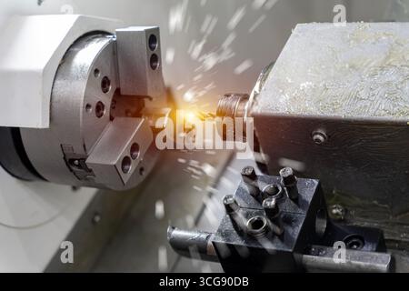 Working closeup CNC turning cutting metal Industry machine iron tools with splash water. Vertical mill metalworking process. Stock Photo