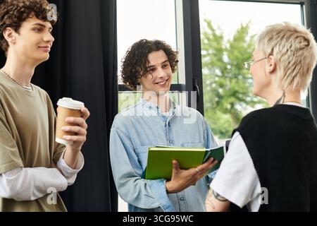 Three young individuals share ideas and laughter in a bright office environment. Stock Photo