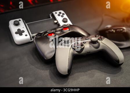 Next Generation joystick game controllers on black background. Stock Photo