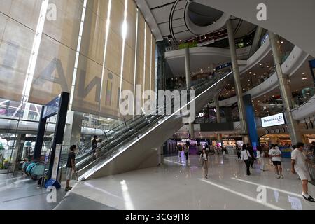 A shopping mall is a large indoor shopping center, usually anchored by department stores. High land prices in populous cities in Southeast Asia have l Stock Photo