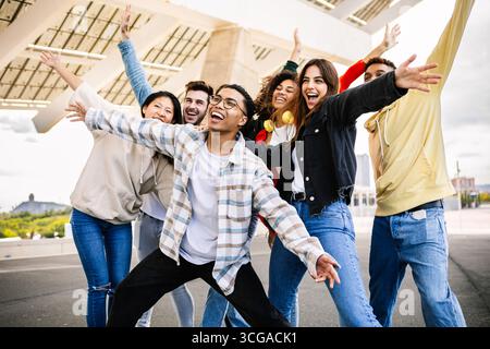 Happy multiracial gen z friends having fun together and smiling outdoors Stock Photo